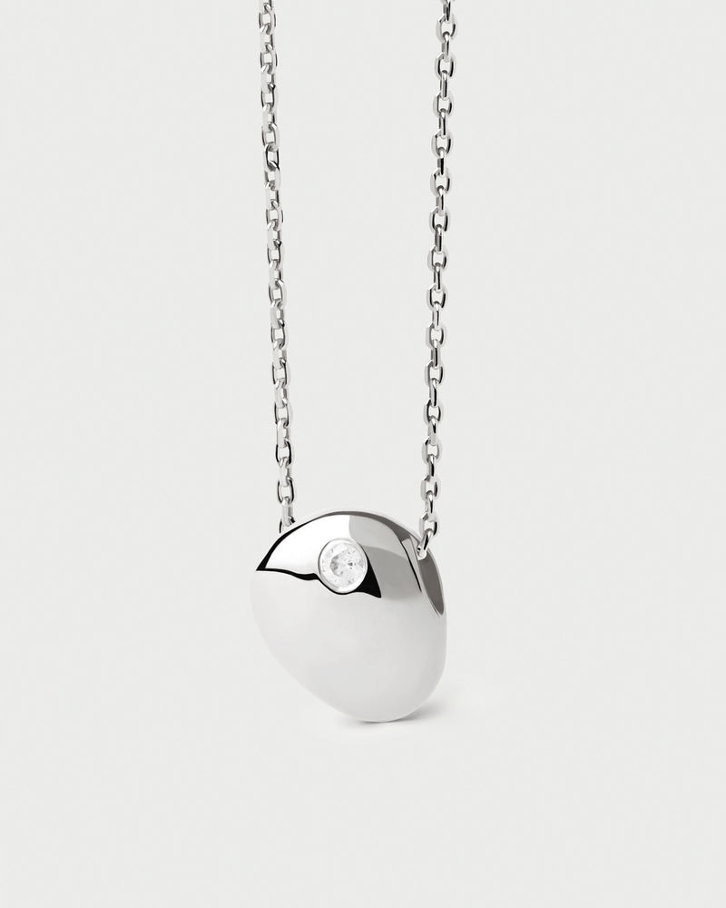 Modern silver necklace with sculptural pendant adorned with white zirconia