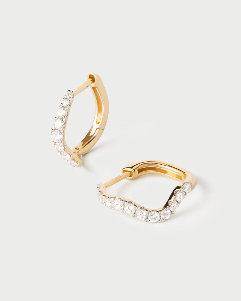 Fluid half eternity hoops featuring an undulating row of round lab-grown diamonds