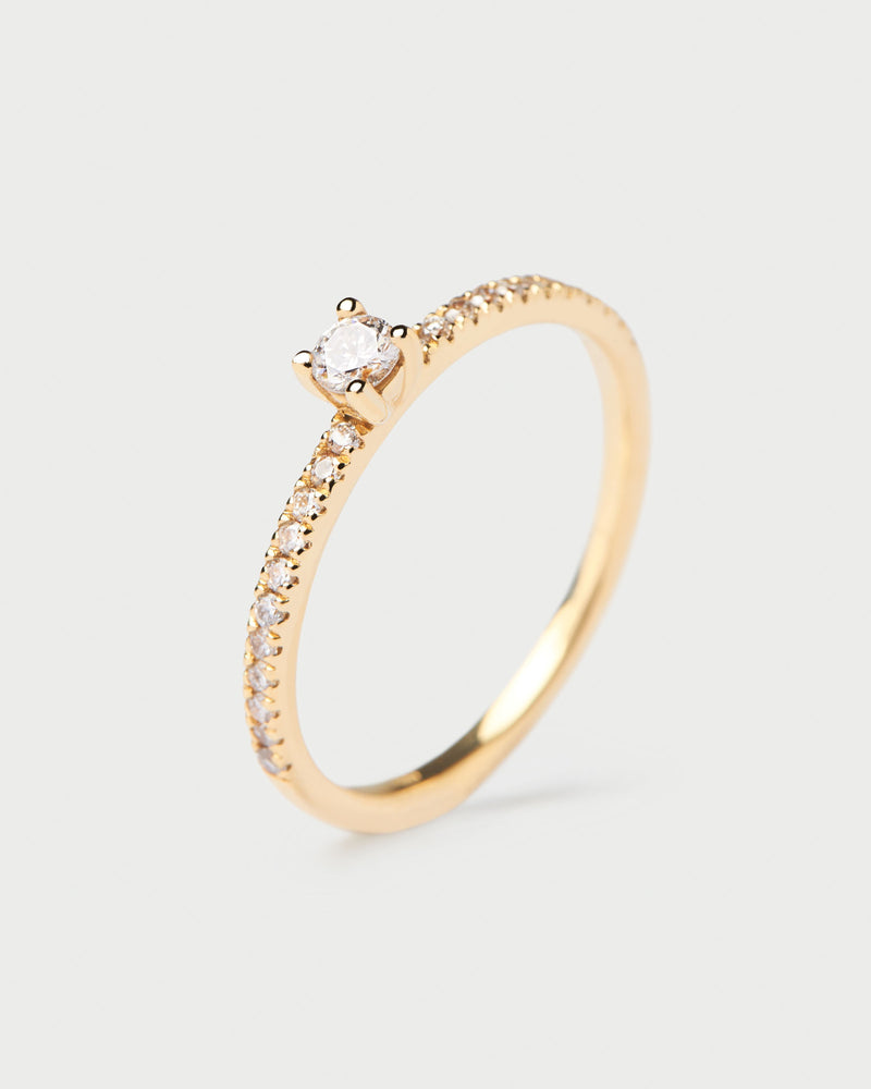 Solid yellow gold ring with a lab-grown diamond eternity band and a round cut center diamond, making 0.31K