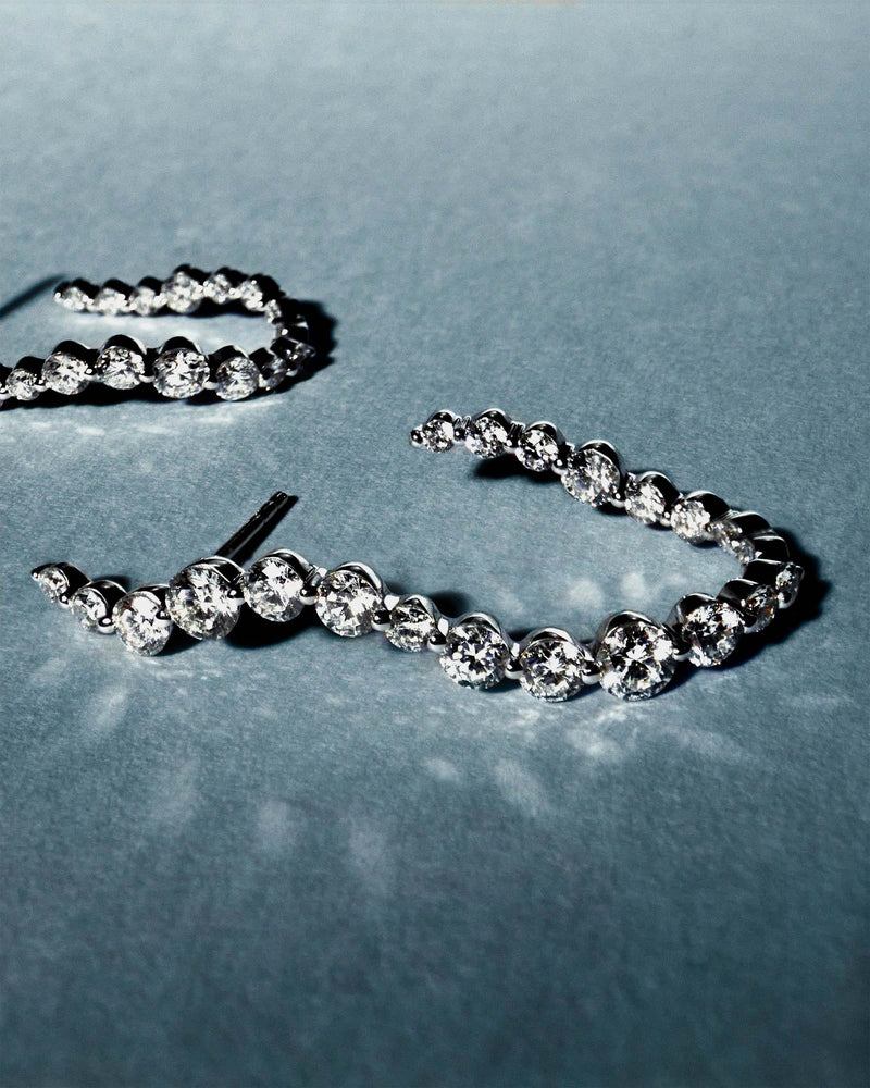 Elegant large semi hoops in 18K white gold featuring an undulating line of lab-grown diamonds